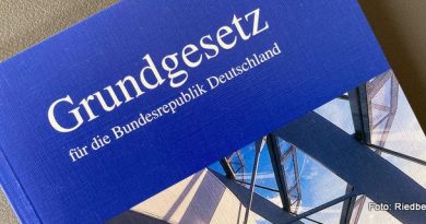 Grundgesetz der Bundesrepublik Deutschland - weiße Schrift auf blauem Grund - darunter ein Bildausschnitt Deutscher Bundestag