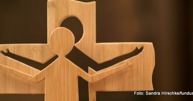 Ein Holzkreuz - 3D - mit ausgeschnittener Jesus-Figur davor - mit ausgebreiteten Armen